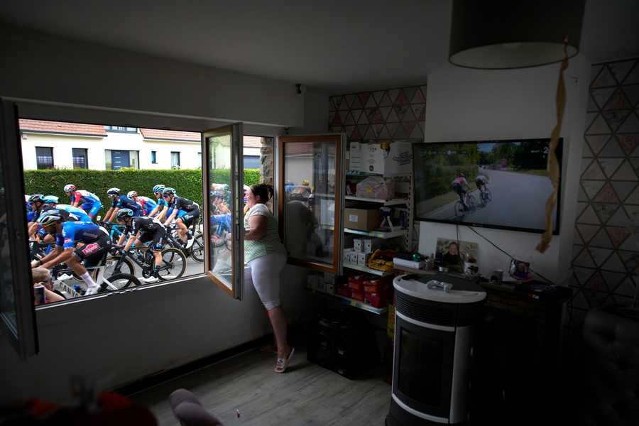 Cycling Tour de France Review Photo Gallery A woman cheers the riders, as she stands at her window, during the fourth stage of the Tour de France cycling race over 171.5 kilometers (106.6 miles) with start in Dunkerque and finish in Calais, France, Tuesday, July 5, 2022.