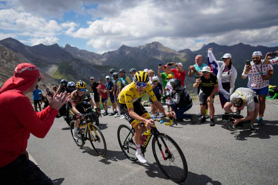 Cycling Tour de France Review Photo Gallery Stage winner and new overall leader Denmark's Jonas Vingegaard, left, and Slovenia's Tadej Pogacar, wearing the overall leader's yellow jersey, climb during the eleventh stage of the Tour de France cycling race over 152 kilometers (94.4 miles) with start in Albertville and finish in Col du Granon Serre Chevalier, France, Wednesday, July 13, 2022.