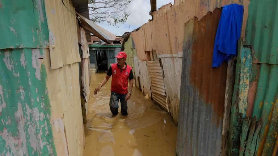 Dominican Republic Tropical Weather Nicasio Gil walks through the stagnant water left by the swollen Duey river, caused by Hurricane Fiona in the Los Sotos neighborhood in Higüey, Dominican Republic, Tuesday, Sept. 20, 2022.