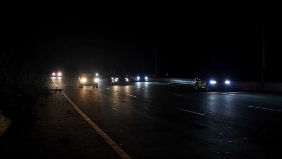 Puerto Rico Tropical Weather Drivers drive on a dark road after the passing of Hurricane Fiona that left the parts of the island without power, in San Juan, Puerto Rico, Tuesday, Sept. 20, 2022.